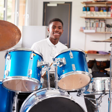 Male,Teenage,Pupil,Playing,Drums,In,Music,Lesson